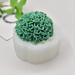 Detailed macro view of marigold flower silicone mold with green wax candle finished product