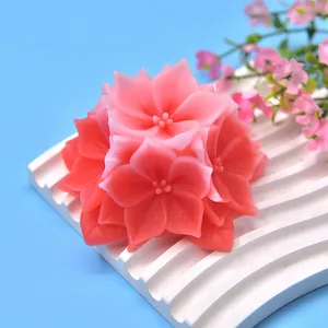 Exquisite pink hydrangea flower scented candle placed on white wavy decorative tray background