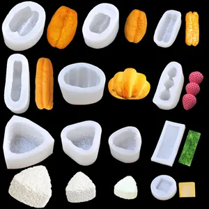 Detailed view of various silicone food molds for croissant, strawberry and rice ball shapes.