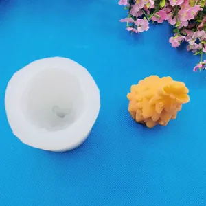 Detailed view of a Christmas tree silicone mold and finished candle on blue background