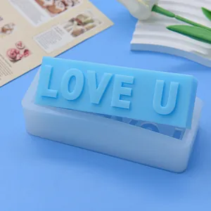 Close-up of LOVE U letter silicone mold with a blue finished candle piece