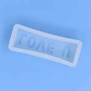 Detailed view of the mirrored LOVE U letter cavities in a white silicone mold for DIY crafts