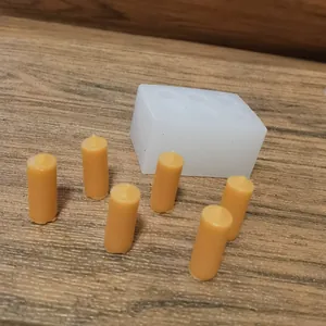 Detailed view of 6-hole mini cylinder candle silicone mold with yellow wax samples