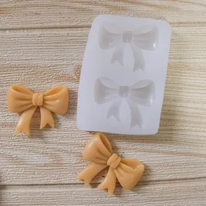 Detailed view of bow tie silicone mold showing finished fondant and chocolate bows