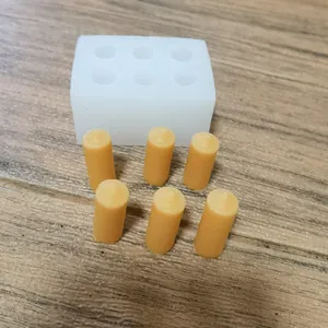 Detailed view of a 6-cavity rectangular silicone mold with wax cylinders