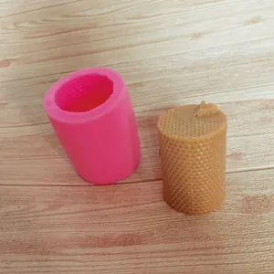 Macro detail of a pink honeycomb silicone mold shown with its finished wax candle