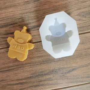 Detail of bear shaped silicone mold and wax sample with HBD engraving for DIY crafts