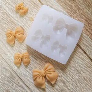Detailed view of silicone bow mold with four different sized cavities and finished samples