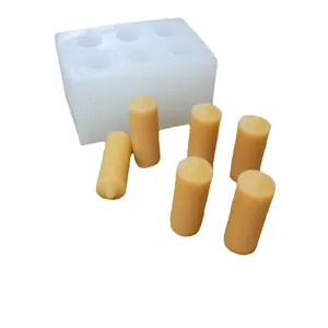 Mini 6-cavity cylindrical aromatherapy candle silicone mold shown with beeswax samples