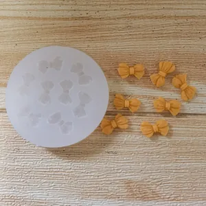 Silicone cake decorating mold with multiple bow cavities and finished fondant bow-ties