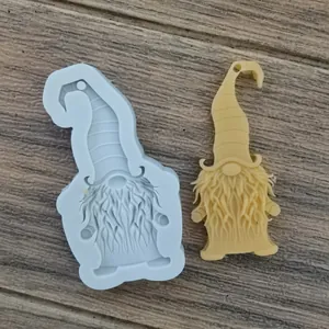 Detailed view of the gnome silicone mold alongside a finished yellow resin craft pendant