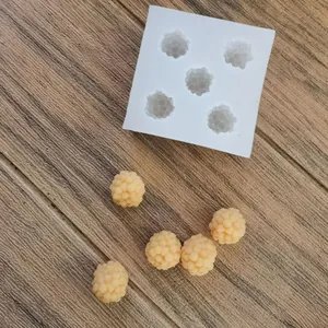 Detailed view of raspberry shaped silicone mold with finished wax samples