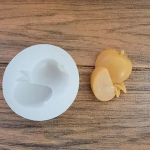 Macro view of apple shape silicone mold with a finished clay craft on wood background