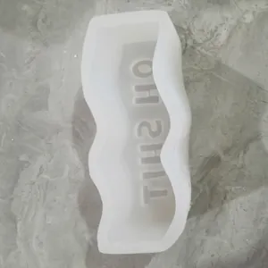 Detail view of wavy silicone mold with 'OH SHIT' letter engraving for DIY crafts