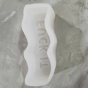 Close-up detail of wavy silicone mold featuring Lucky It phrase for DIY candle making