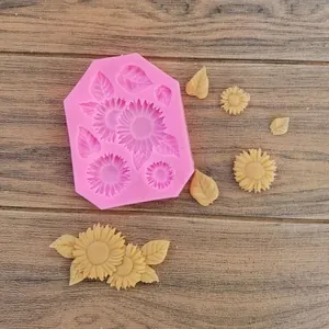 Vista dettagliata dello stampo in silicone a girasole rosa con fiori di fondente crema