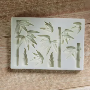 Macro detail of a silicone mold featuring bamboo and leaf shapes for cake decorating.