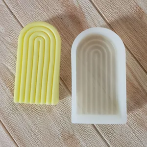 Detailed macro view of arched silicone mold alongside its yellow geometric candle output