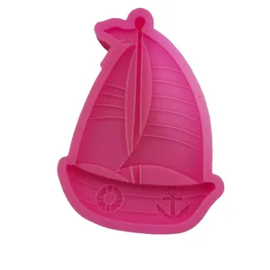 Pink sailboat-shaped silicone mold for DIY resin casting and fondant crafts.