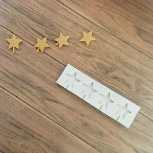 Detailed view of white 4-cavity star silicone mold for fondant and chocolate cake decoration