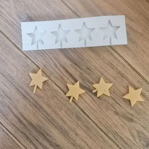 Detail view of 4-cavity star silicone mold with finished star-shaped fondant pieces