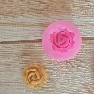 Macro detail view of a rose-shaped silicone mold with a finished fondant flower piece