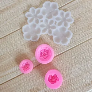 Close-up of various flower-shaped silicone molds for fondant and chocolate cake decorating.