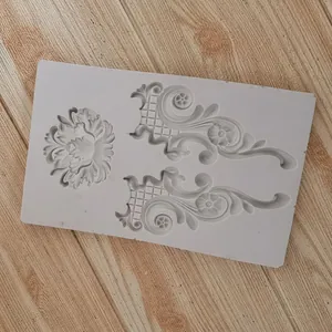 Macro view of European relief silicone mold with ornate scroll and flower patterns