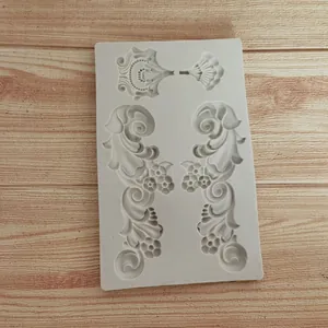 Detailed macro view of a grey European relief silicone mold on a wood surface.