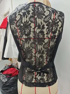 Close-up detail of an elegant black women's vest featuring a delicate floral lace back design