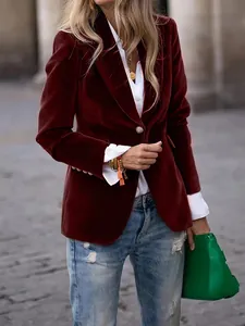 Sophisticated close-up of a premium burgundy velvet blazer with stylish golden buttons.