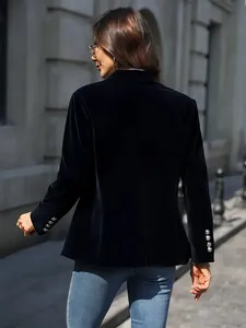 Back view of elegant black velvet blazer jacket for women in urban street style