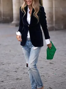 Elegant navy blue velvet blazer for women styled with a chic green woven handbag