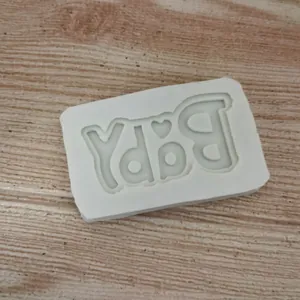 High-quality white silicone mold showing detailed reverse BABY text with heart icon