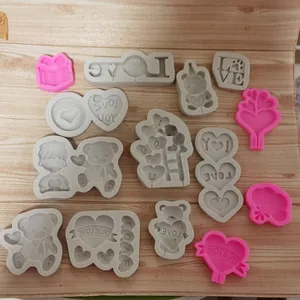 Detailed view of various heart and bear shaped Valentine's Day silicone DIY craft molds.
