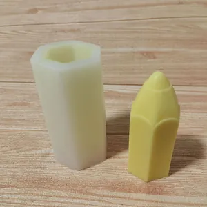 Primer plano de un molde de silicona hexagonal junto a una vela amarilla con forma de lápiz.