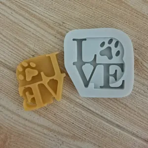 Close-up detail of LOVE silicone mold featuring a paw print design and wax sample.