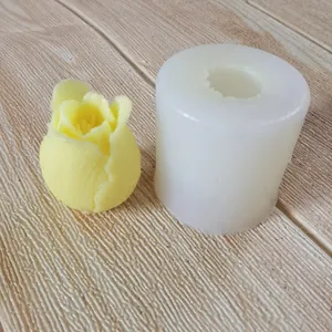 Detailed view of tulip flower silicone mold with finished yellow candle on textured background