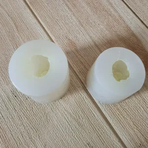 Close-up detail of white tulip flower silicone molds for candle making on wooden surface