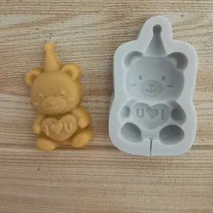 Detail view of bear silicone mold and finished chocolate bear with I Love You heart