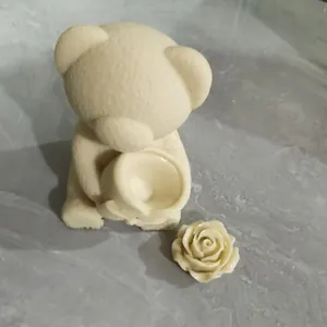 Macro view of 3D bear and rose flower silicone molds for chocolate candle making