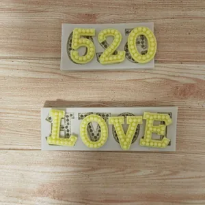 Detail view of silicone molds for pearl-textured 520 and LOVE cake decorations.