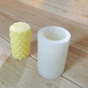 Cylindrical honeycomb pattern silicone mold for DIY candles shown with finished wax