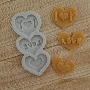 Detailed view of heart-shaped silicone mold with LOVE and I Love You text designs