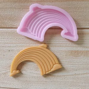 Dettaglio macro dello stampo in silicone arcobaleno e nuvola con campione finito su legno