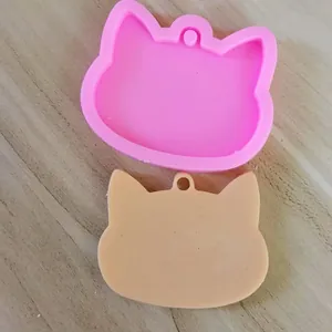 Close-up view of a cat-shaped silicone mold and finished resin casting for DIY keychain crafts