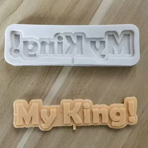 Detailed macro view of white silicone mold and finished My King fondant cake topper decoration