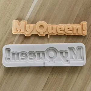 Detailed macro view of silicone cake mold with 'My Queen!' lettering for toppers