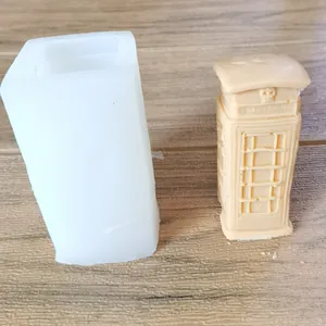 Detailed view of the silicone mold and finished telephone booth candle for DIY crafts