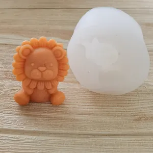 Detailed view showing a 3D cartoon lion silicone mold and a finished orange craft